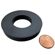 Load image into Gallery viewer, CR250N Ceramic Ring Magnet - 45 Degree Angle View Compared to a Penny