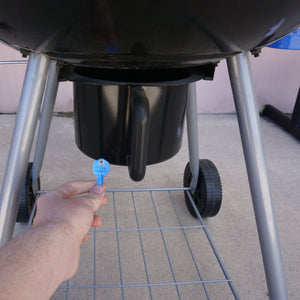 50663 Magnetic Key, KW1-66 Blue - Hand Holding Blue Magnetic Key Beneath a Barbeque Grill