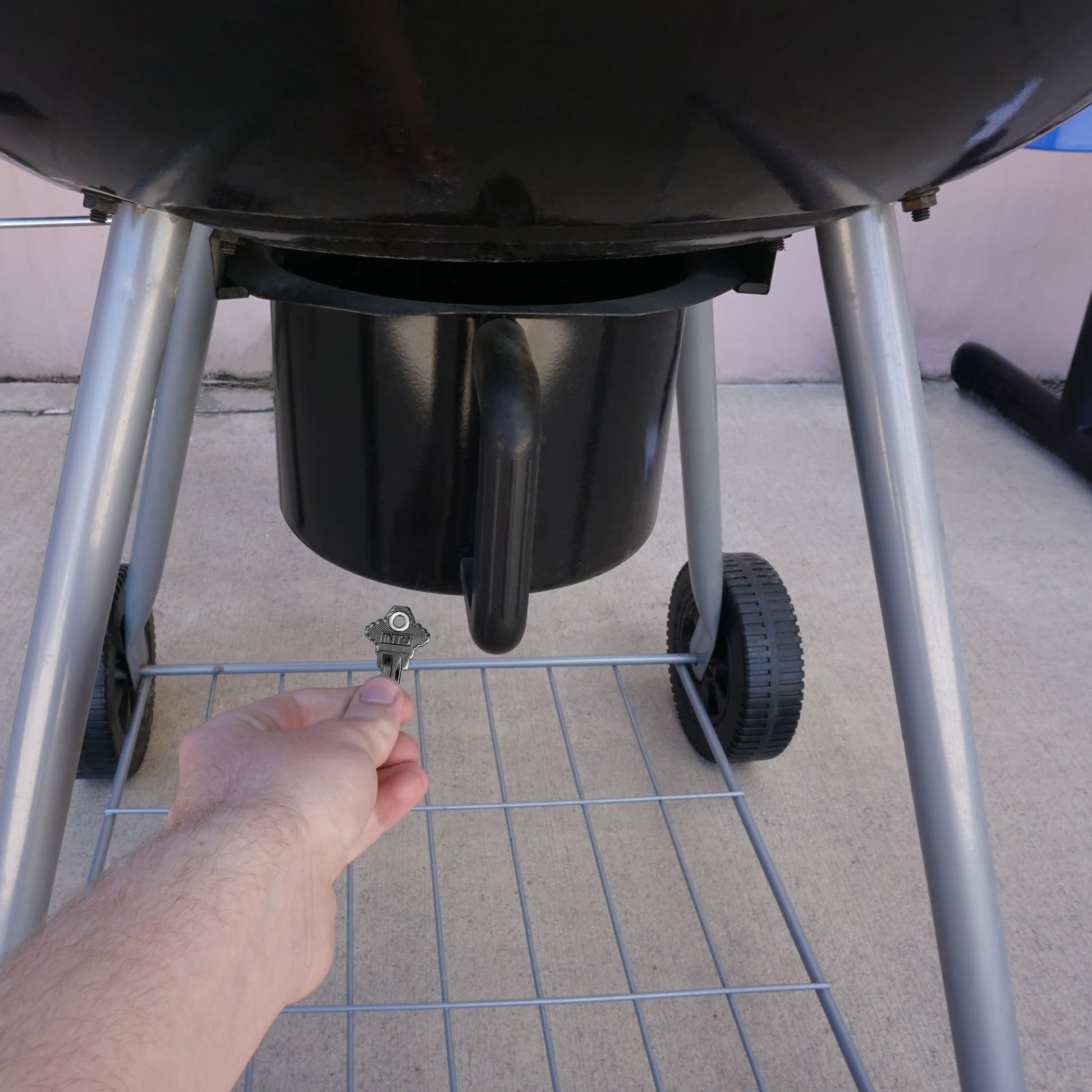 Load image into Gallery viewer, 50686 Magnetic Key, SC1-68 Black - Hand Holding Magnetic Key Next to a Barbeque Grill