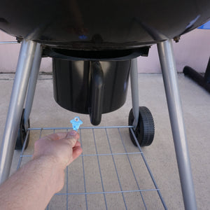 50683 Magnetic Key, SC1-68 Blue - Hand Holding Blue Magnetic Key Beneath a Barbeque Grill